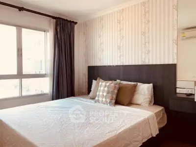Cozy bedroom with stylish wallpaper and large window for natural light