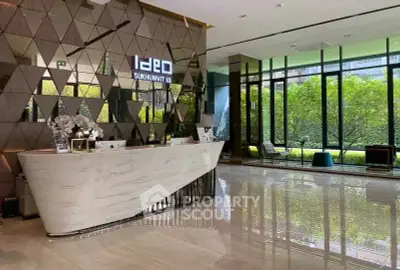 Luxurious building entrance with modern design and lush garden view, perfect for upscale living.