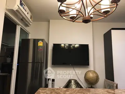 Modern living room with wall-mounted TV and stylish lighting fixture.