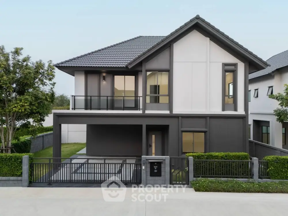 Modern two-story house with sleek design and spacious front yard