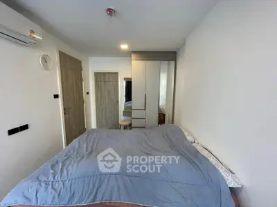 Modern bedroom with sleek design and ample storage in a contemporary apartment.