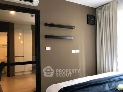 Modern bedroom with sleek shelves and large window for natural light.