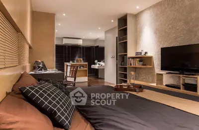 Luxurious modern bedroom with stylish decor and open layout, featuring a cozy bed and entertainment area.
