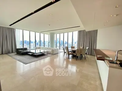 Luxurious open-plan living room with panoramic city views and elegant furnishings.