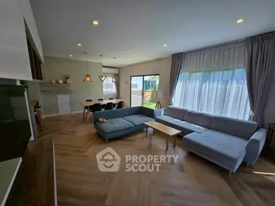 Spacious modern living room with large windows and elegant decor