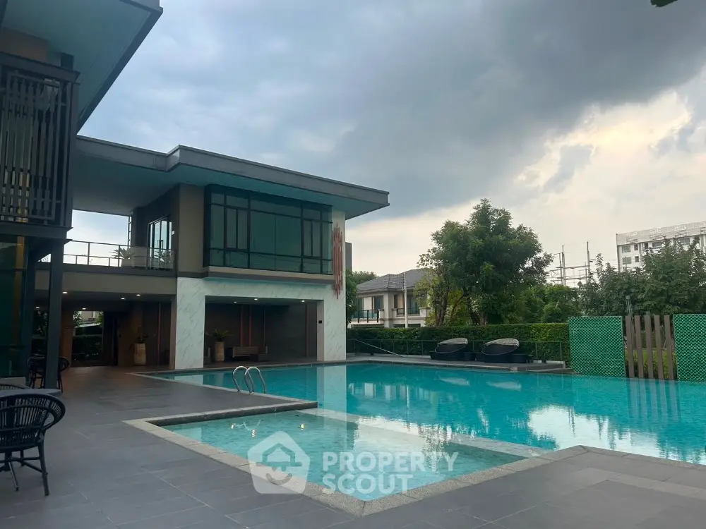 Luxurious modern home with stunning pool and spacious outdoor area, perfect for relaxation and entertainment.