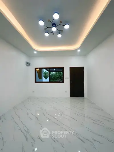 Modern living room with elegant lighting and marble flooring, featuring a large window for natural light.