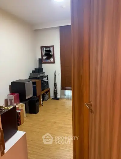 Cozy study room with wooden flooring and ample storage space.
