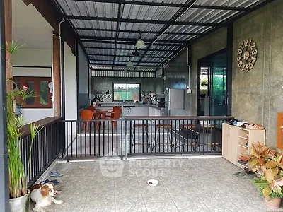 Spacious open-air patio with modern kitchen and dining area, perfect for entertaining.