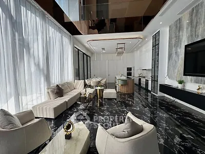 Luxurious modern living room with marble flooring and open kitchen layout