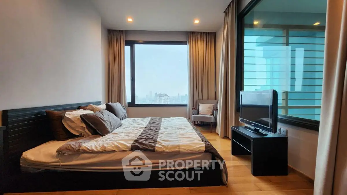 Spacious modern bedroom with city view and elegant decor