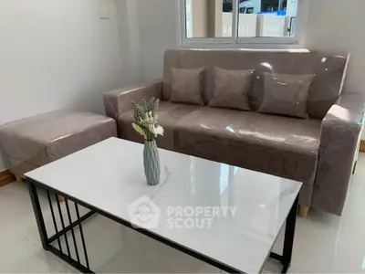 Modern living room with sleek sofa and elegant marble coffee table