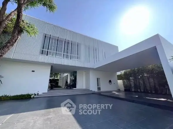 Stunning modern white villa with sleek architecture and spacious driveway