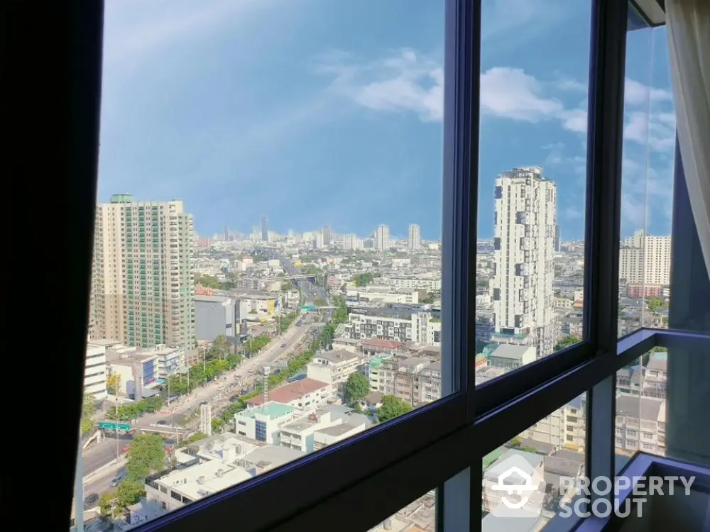 Stunning cityscape view from high-rise apartment window showcasing urban skyline.