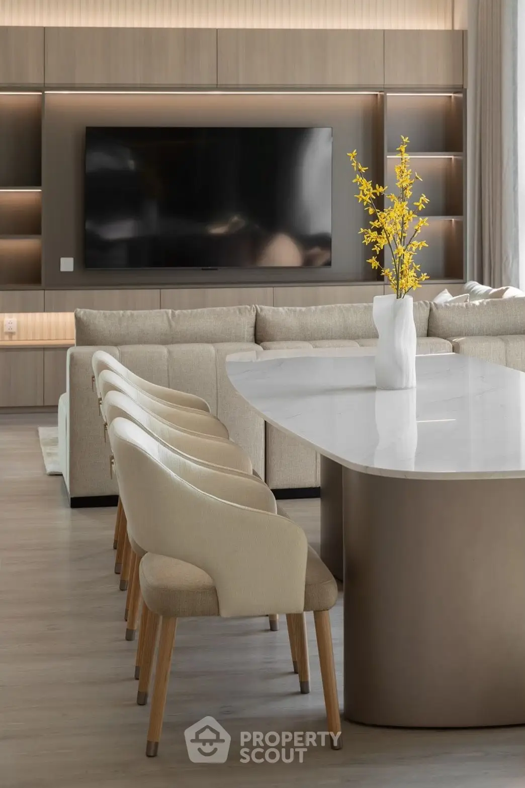 Luxurious modern living room with elegant dining area and large TV, perfect for entertaining.