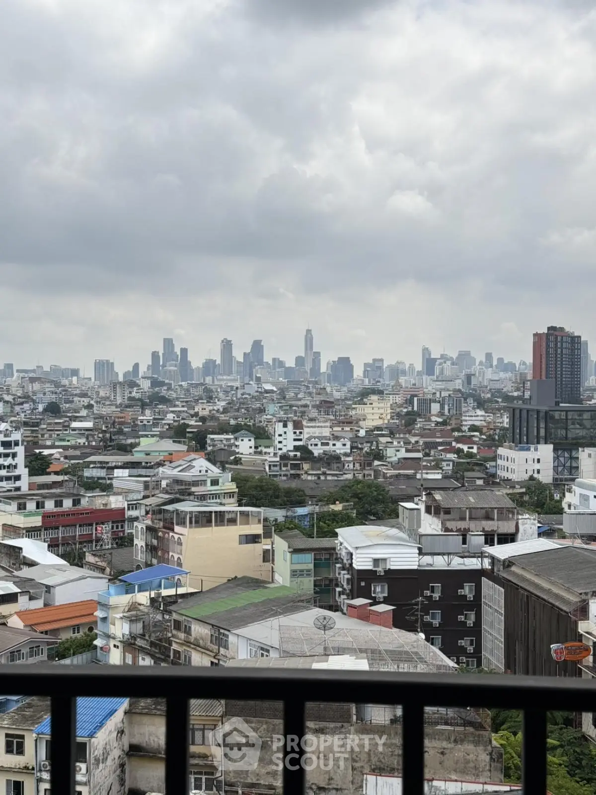 Stunning cityscape view from a high-rise balcony overlooking urban skyline.