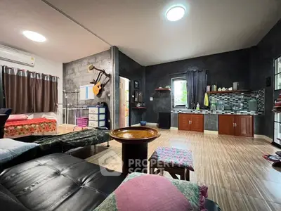 Spacious studio apartment with modern decor and open kitchen layout