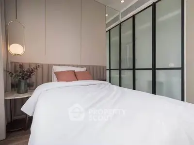 Modern bedroom with elegant design and cozy ambiance, featuring a stylish bed and contemporary lighting.