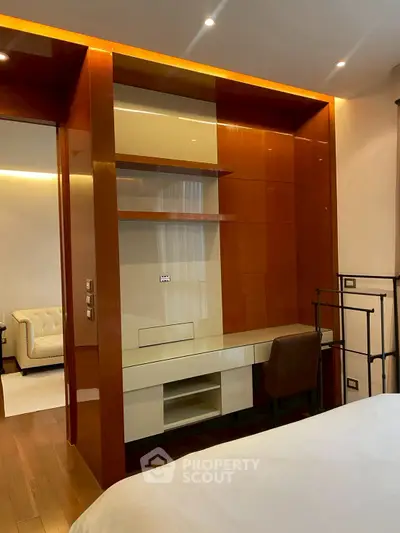 Modern bedroom with built-in desk and shelving, featuring warm wood tones and sleek design.