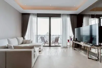 Spacious living room with modern decor and balcony view in luxury apartment.