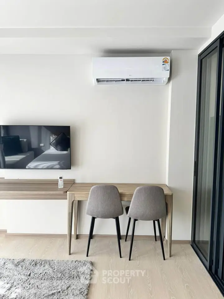 Modern living room with sleek furniture and air conditioning, perfect for comfortable living.
