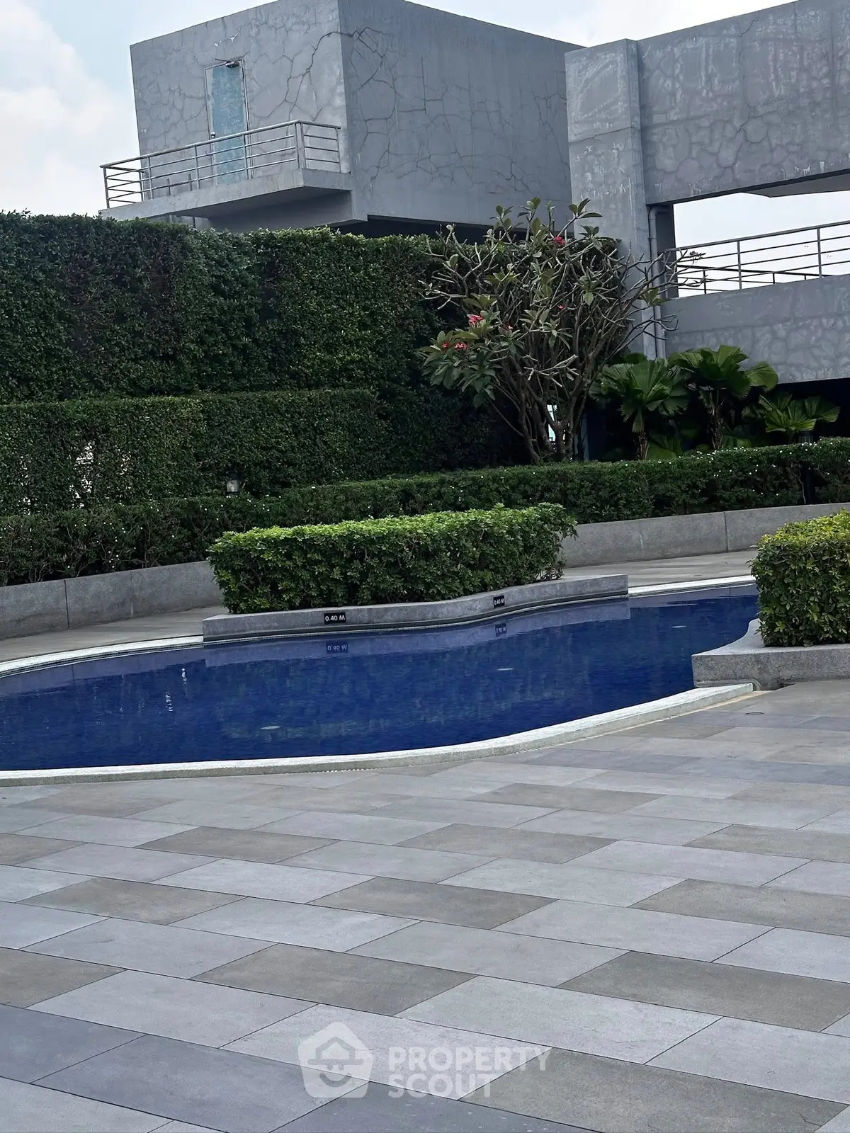 Luxurious modern pool area with lush greenery and sleek architecture