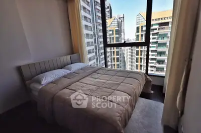 Spacious bedroom with stunning city view in modern high-rise apartment