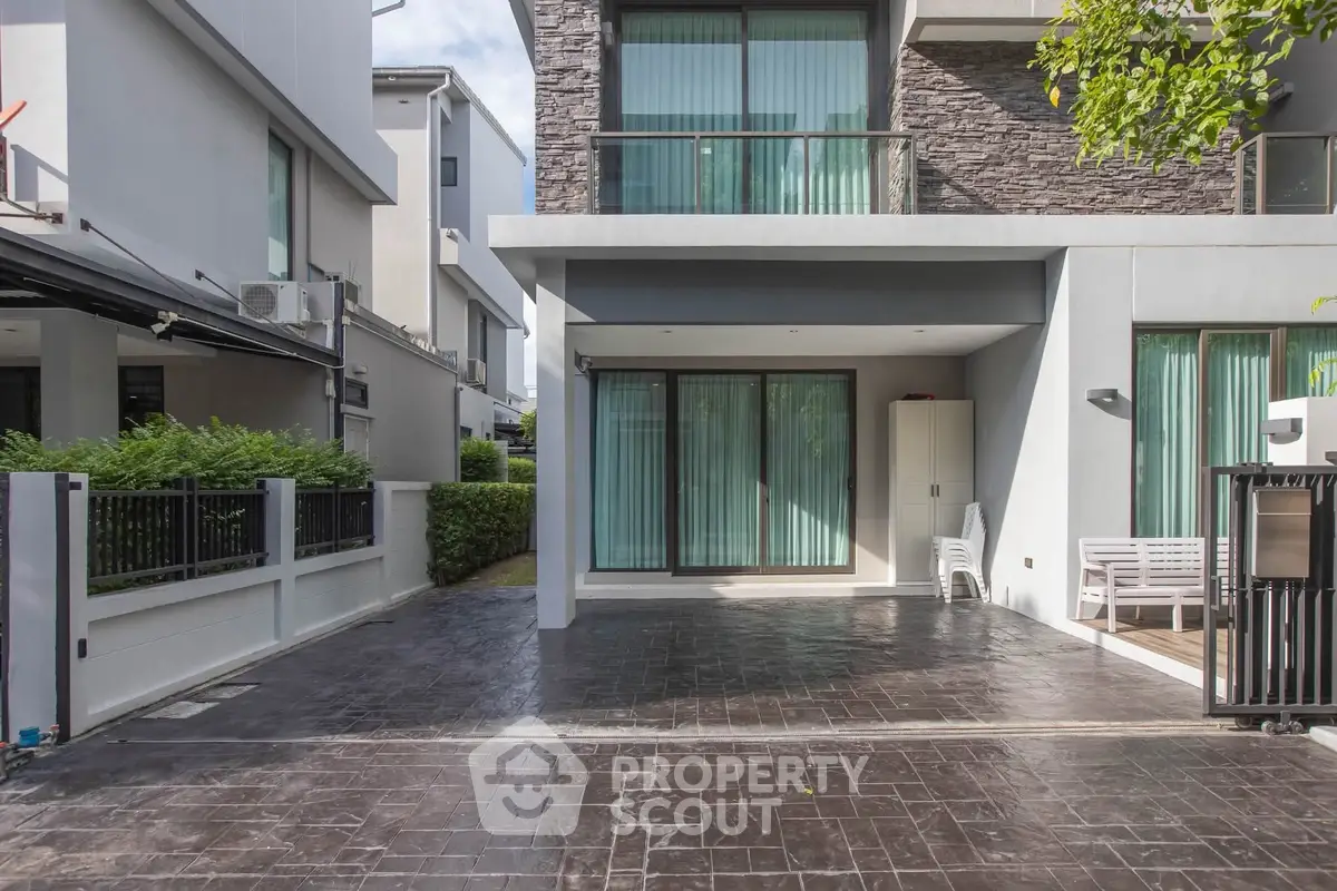 Modern townhouse exterior with spacious driveway and sleek design