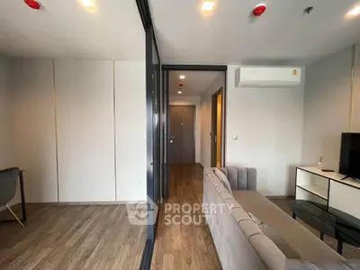 Modern living room with sleek design and air conditioning in a stylish apartment.