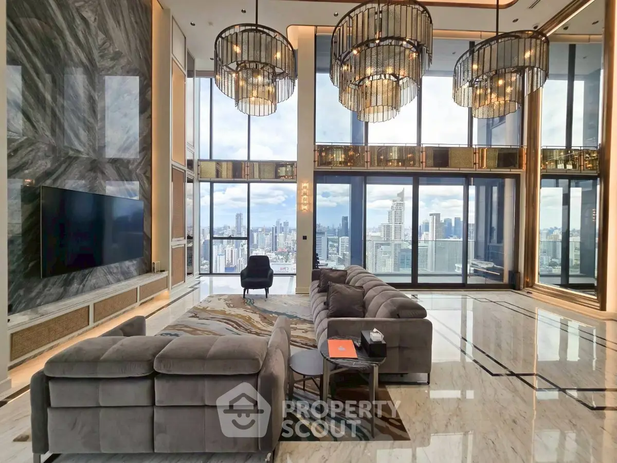 Luxurious high-rise living room with stunning city views and elegant chandeliers.