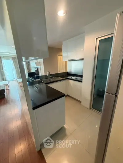 Modern kitchen with sleek black countertops and open layout design