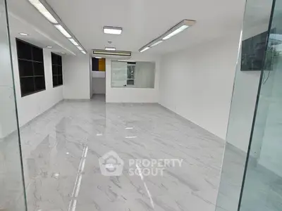 Spacious modern office space with marble flooring and glass partitions
