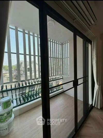 Spacious balcony with sliding glass doors and a scenic view, perfect for relaxation and outdoor enjoyment.