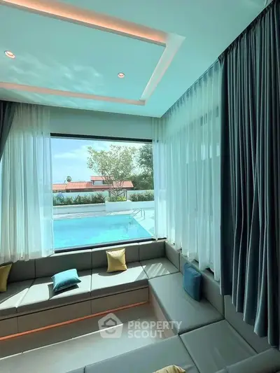 Luxurious living room with pool view and elegant curtains