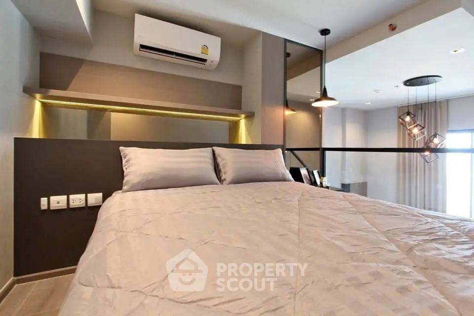 Modern bedroom with stylish decor and air conditioning in a contemporary apartment.