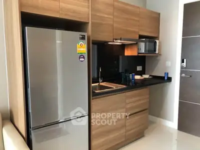 Modern kitchen with sleek wooden cabinets and stainless steel appliances