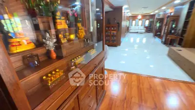 Spacious living room with elegant wooden flooring and decorative accents