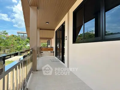 Modern balcony with sleek railing and garden view in contemporary home