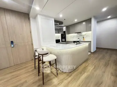 Modern kitchen with sleek design and open layout, featuring a stylish island and contemporary appliances.