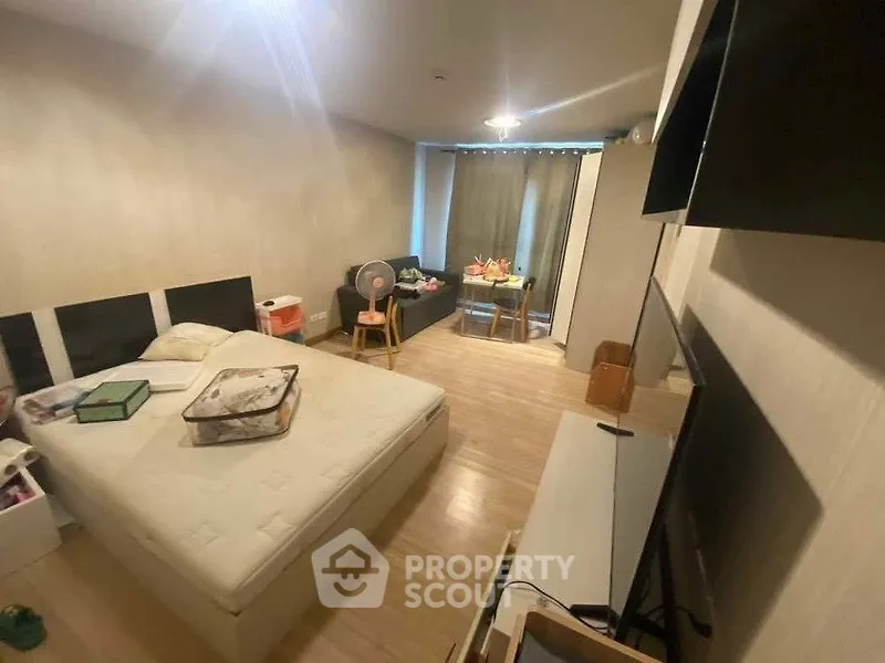 Spacious bedroom with modern decor and cozy seating area