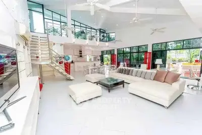 Spacious modern living room with high ceilings and large windows