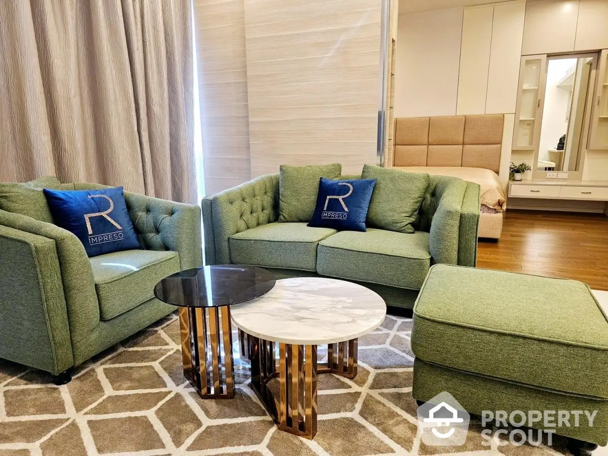 Elegant living room with stylish green sofas and modern coffee table in a cozy apartment setting.