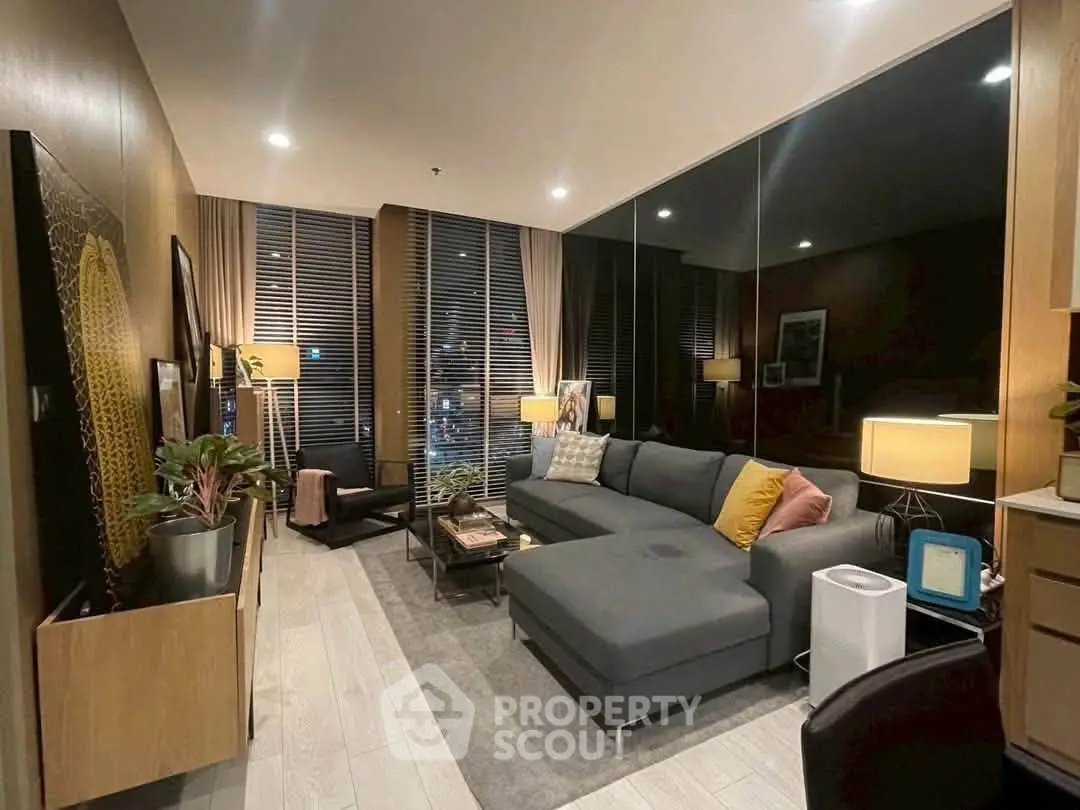 Modern living room with stylish decor and large windows in a luxury apartment.