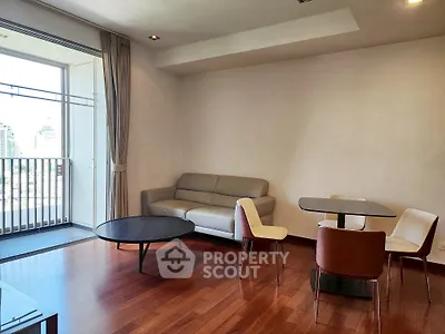 Spacious living room with modern furniture and city view balcony.