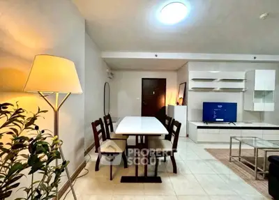 Modern living room with dining area, stylish furniture, and ambient lighting