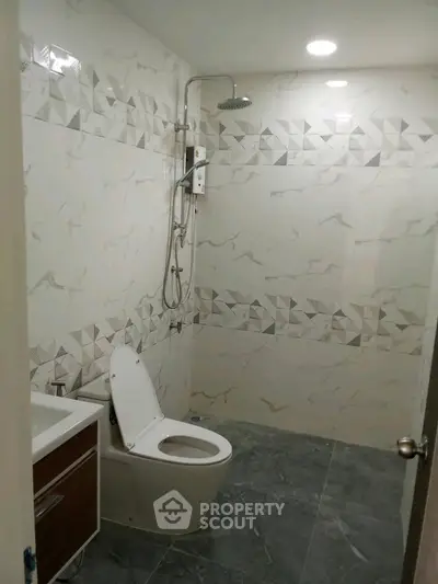 Modern bathroom with elegant tile design and rainfall showerhead