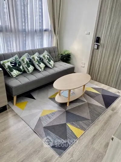 Modern living room with stylish sofa, geometric rug, and natural light from large windows.