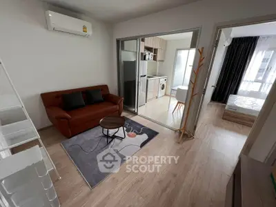 Modern apartment interior with open layout, featuring a cozy living room and stylish kitchen.