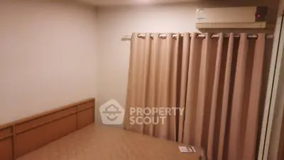 Cozy bedroom with air conditioning and neutral decor, perfect for relaxation.