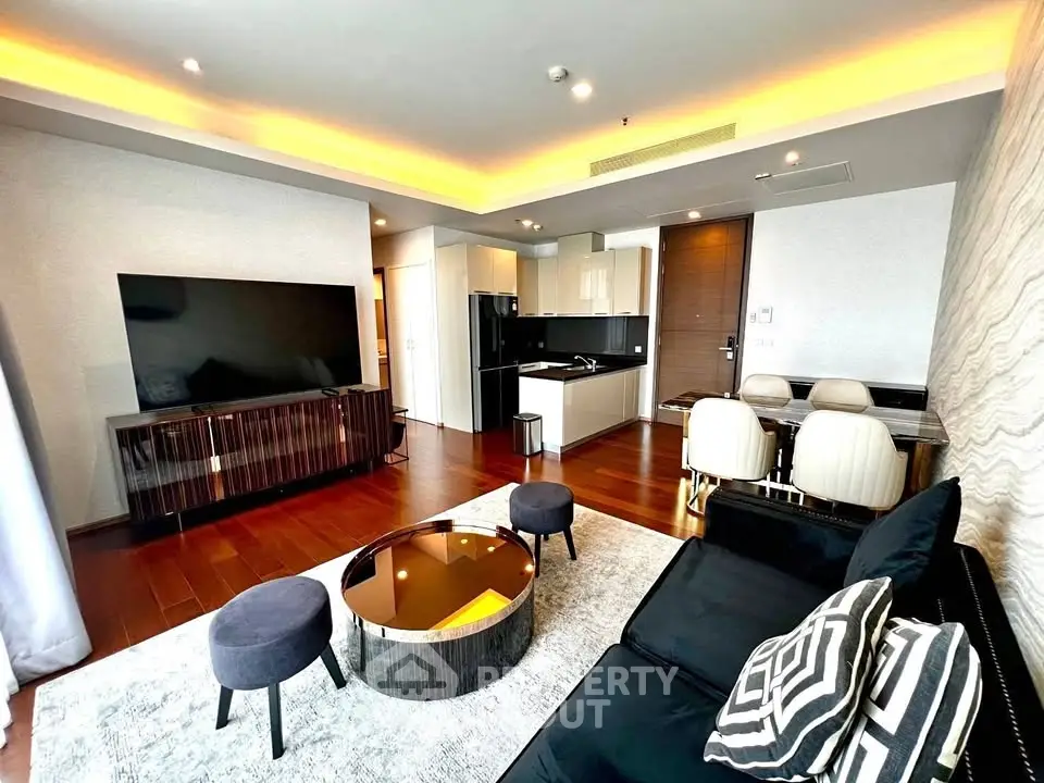 Luxurious modern living room with open kitchen, sleek furniture, and ambient lighting.